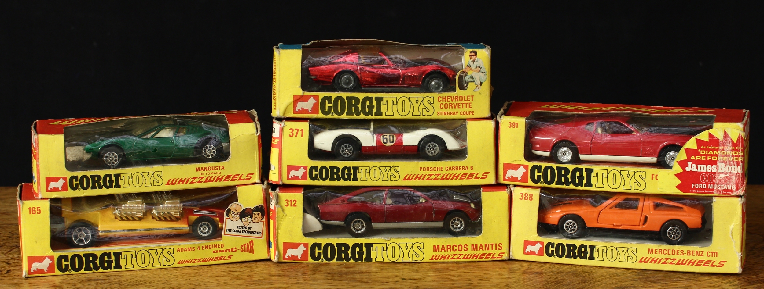 Corgi Toys including Whizzwheels, comprising 165 Adams four engined drag-star, orange and red body, window boxed; 203 Mangusta De Tomaso, dark green body, window boxed; 300 Chevrolet Corvette Stingray coupe, metallic red body with black bonnet and decals, window boxed; 312 Marcos Mantis, dark red body, window boxed; 371 Porsche Carrera 6, white body with red bonnet and doors with decals, window boxed; 388 Mercedes-Benz C111, orange body, window boxed and 391 Ford Mustang Mach 1, red body with black bonnet, window boxed (7)