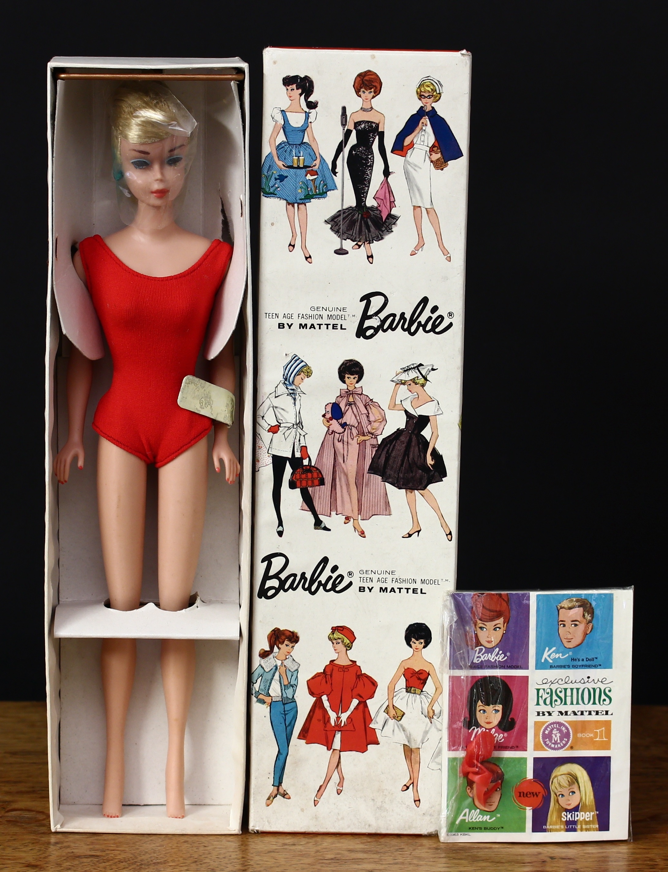 A 1960’s Mattel Barbie stock No.850 ponytail fashion doll, ash blonde hair, blue side glancing eyes, wearing a red one piece swimsuit, marked ‘MIDGE T.M. © 1962 BARBIE BY MATTEL INC PATENTED’ to the right side of buttock, cm high, boxed with clear protective polythene piece to head, tag to arm, inner cardboard packaging piece, stand and literature with a pair of red plastic high heeled shoes in sealed packet