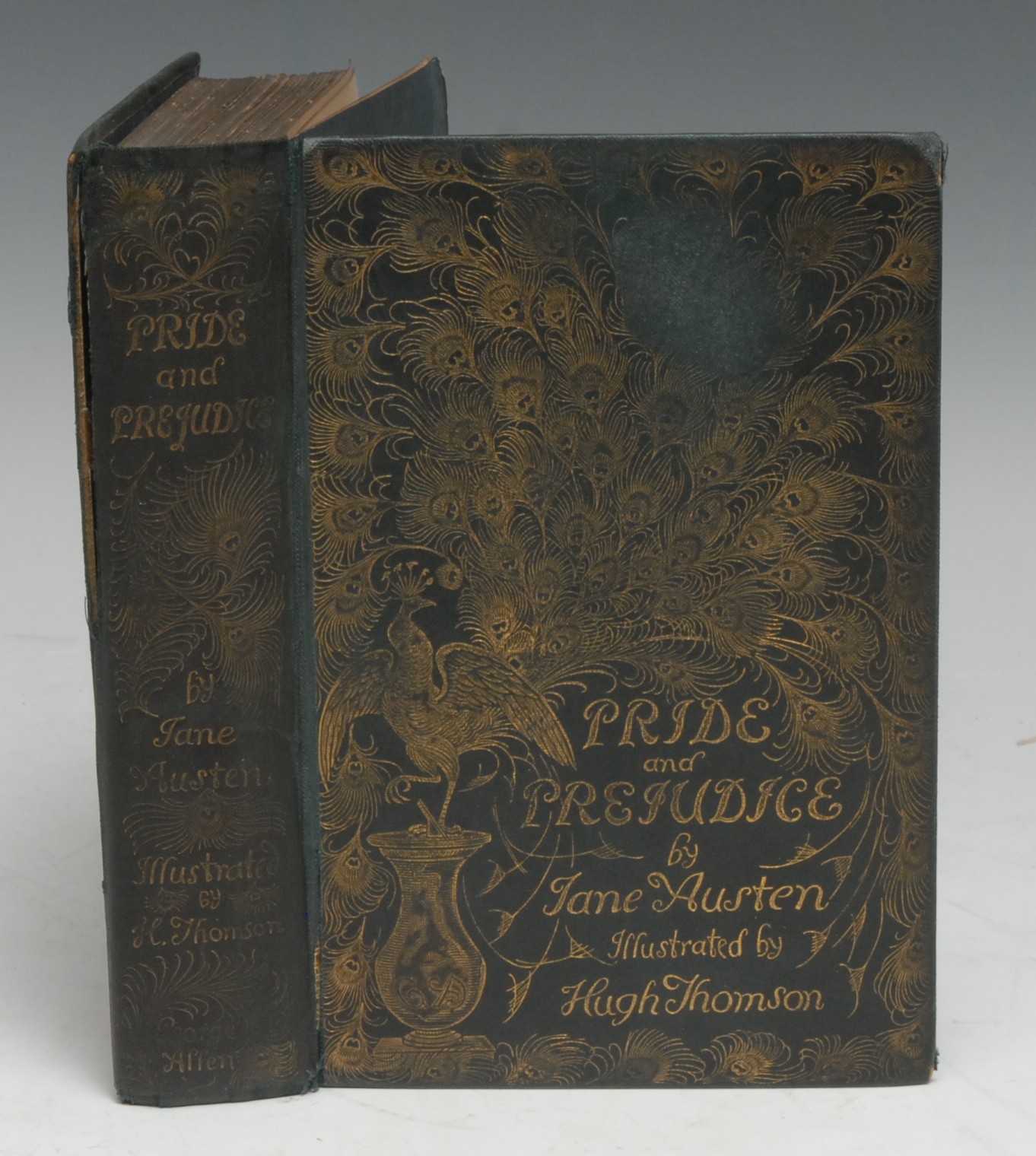 Austen (Jane) & Thomson (Hugh, illustrator), Pride and Prejudice, first Thomson illustrated edition, London: George Allen, 1894, pp: xxvii, [1] (blank), 476, frontispiece and in-text illustrations, contemporary pictorial cloth gilt with a peacock and its feathers, as issued, (rubbed, upper-cover loose with movement, torn spine splits, upper-gutter split with the first quire loose, the contents loosening but present), all-edges gilt, Sheffield School Board award bookplate to recto pastedown, 8vo, [1]
