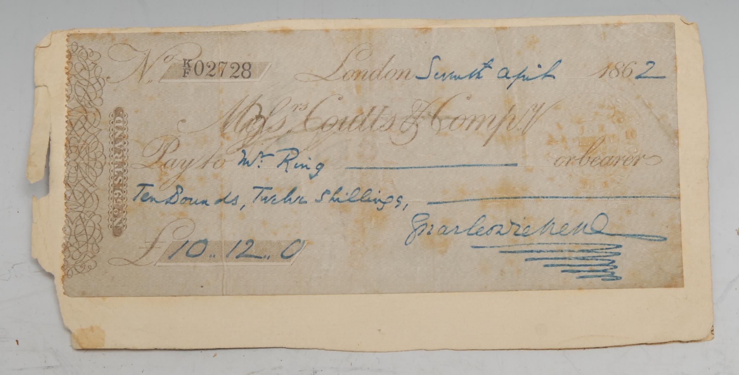 Charles Dickens FRSA (1812-1870) - an autographed cheque signed and paid to "W: Ring" for the sum of "Ten Pounds, Twelve Shillings" drawn on Messrs. Coutts & Comp:y, dated Seventh April 1862, mounted, [1]