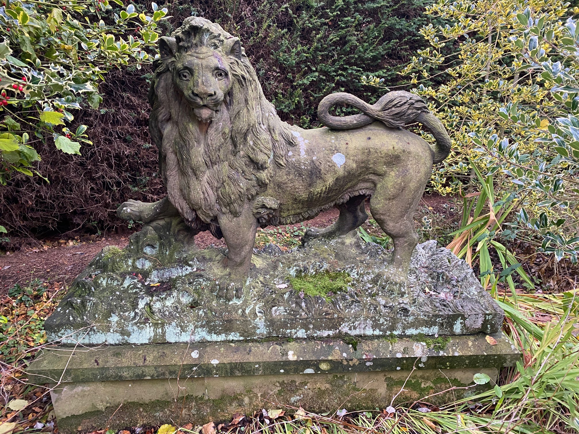 The Arundel Lion - A good and large 19th century carved sandstone Lion passant, naturalistically carved standing with right paw raised, on a rocky leafy base, now raised on a later rectangular plinth, the lion 141cm high, 216cm wide, the plinth 230cm wide, 82cm high  Provenance: The Arundel Lions were one of Sheffield's well known landmarks. Raised high at the gateway of the Johnson Matthey factory until it was cleared to build Hallam University.