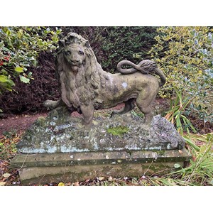 The Arundel Lion - A good and large 19th century carved sandstone Lion passant, naturalistically carved standing with right paw raised, on a rocky leafy base, now raised on a later rectangular plinth, the lion 141cm high, 216cm wide, the plinth 230cm wide, 82cm high  Provenance: The Arundel Lions were one of Sheffield's well known landmarks. Raised high at the gateway of the Johnson Matthey factory until it was cleared to build Hallam University.