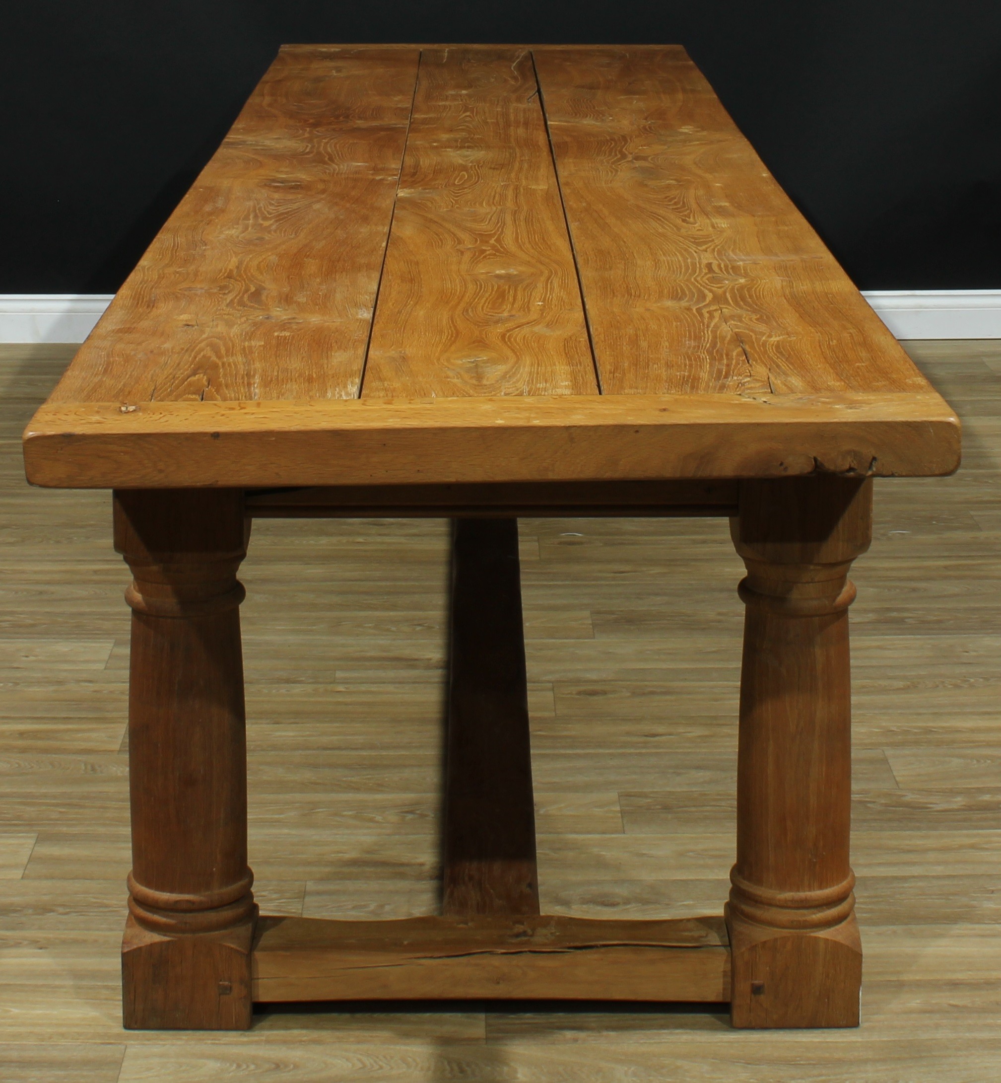 A substantial oak refectory trestle dining table, planked rectangular top, each plank a single piece, turned and blocked supports, rectangular stretchers, 76.5cm high, 410.5cm long, 92.5cm wide