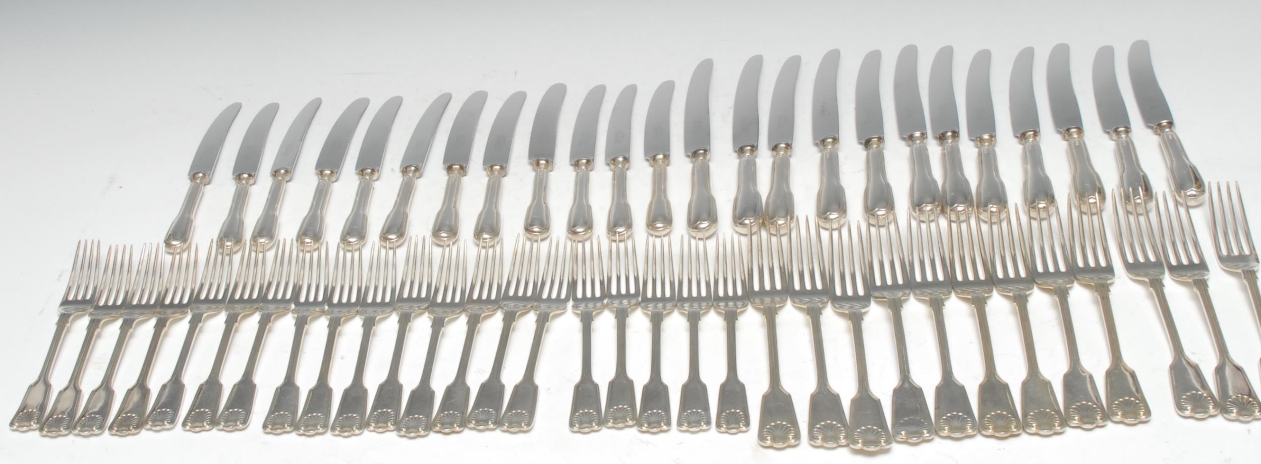 An Elizabeth II silver Fiddle, Thread and Shell pattern table service, comprising six table spoons, twelve table knives, twelve table forks, twelve pairs of fish knives and forks, twelve dessert knives, twelve dessert forks, twelve soup spoons, twelve dessert spoons, twelve fruit spoons, twelve teaspoons, and twelve grapefruit spoons, Cooper Brothers & Sons, Sheffield 1967, [138], 6,922g excluding knives