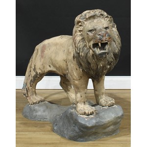 A substantial floor-standing cold painted bronze, of a snarling lion, standing on a rocky outcrop, 91.5cm high, 112cm long