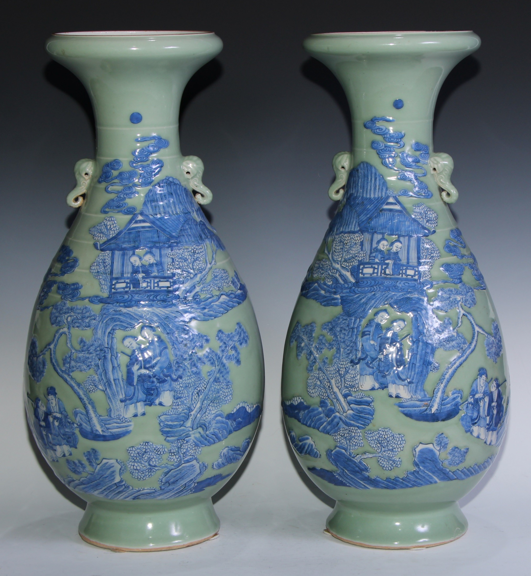 A pair of large Chinese ovoid vases with everted rims, styalised Elephant handles to neck, moulded and painted in blue with figures in formal gardens, on a celadon ground, 60cm high, c.1880