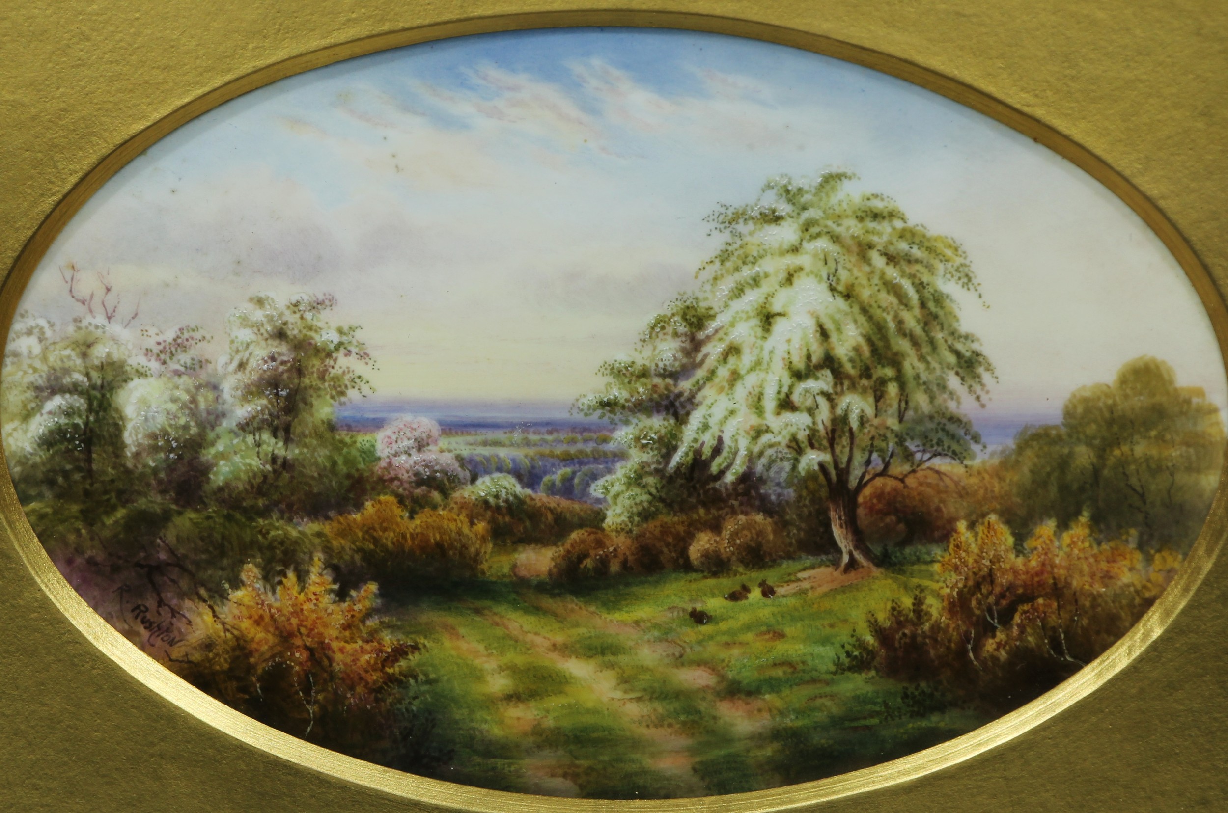 A Royal Worcester oval plaque painted by Raymond Rushton, signed, with rabbits grazing in blooming spring meadows, printed marks in puce, date code for 1918 and titled Hawthorn Blossom, the frame with original backboard bearing an inscribed label from H. G. Stephenson, Ltd, China and Glass Shops, Barton Arcade, Manchester, 23cm x 15cm