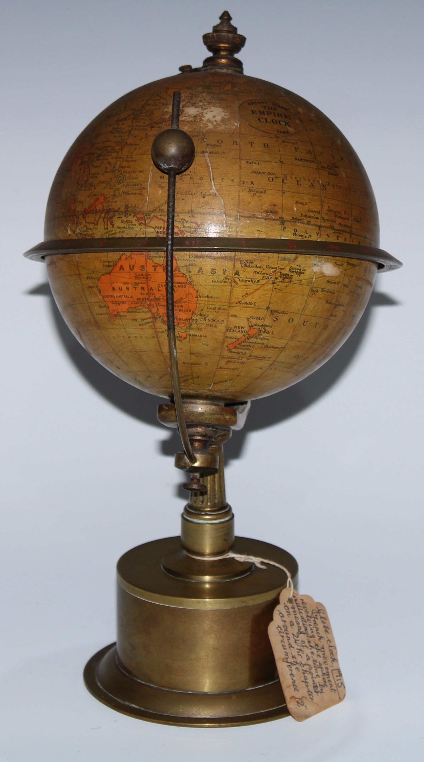 A late 19th century terrestrial globe library timepiece, The Empire Clock, patent 19460, a printed gores, the horizon ring engraved with chapter of Roman numerals, orrery type indicator, the brass base with fluted pillar,   30cm high, c.1900