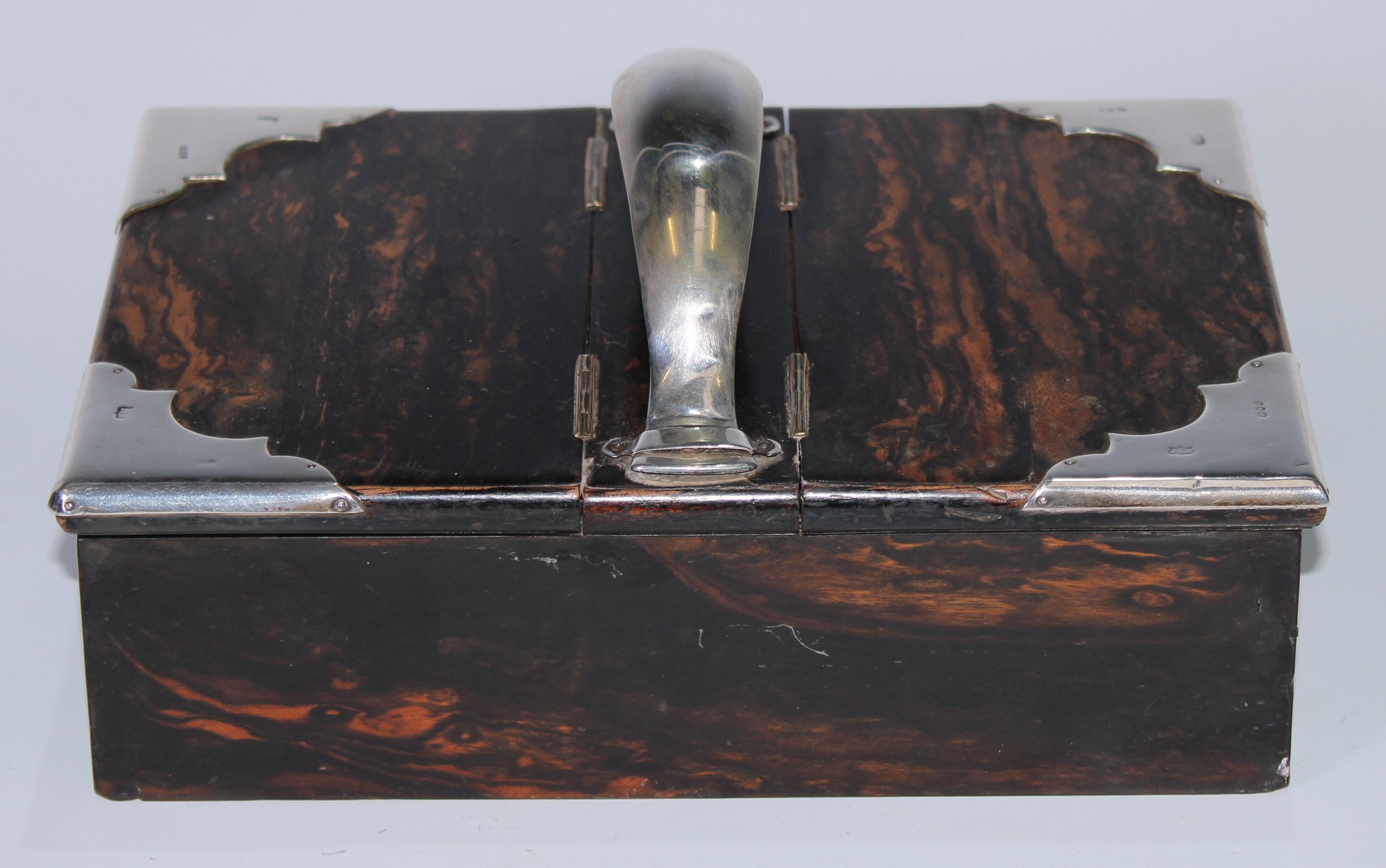 A Victorian silver mounted coromandel cigar box or waiter, arched butler's handle flanked by a pair of hinged covers, 23.5cm long, London 1895