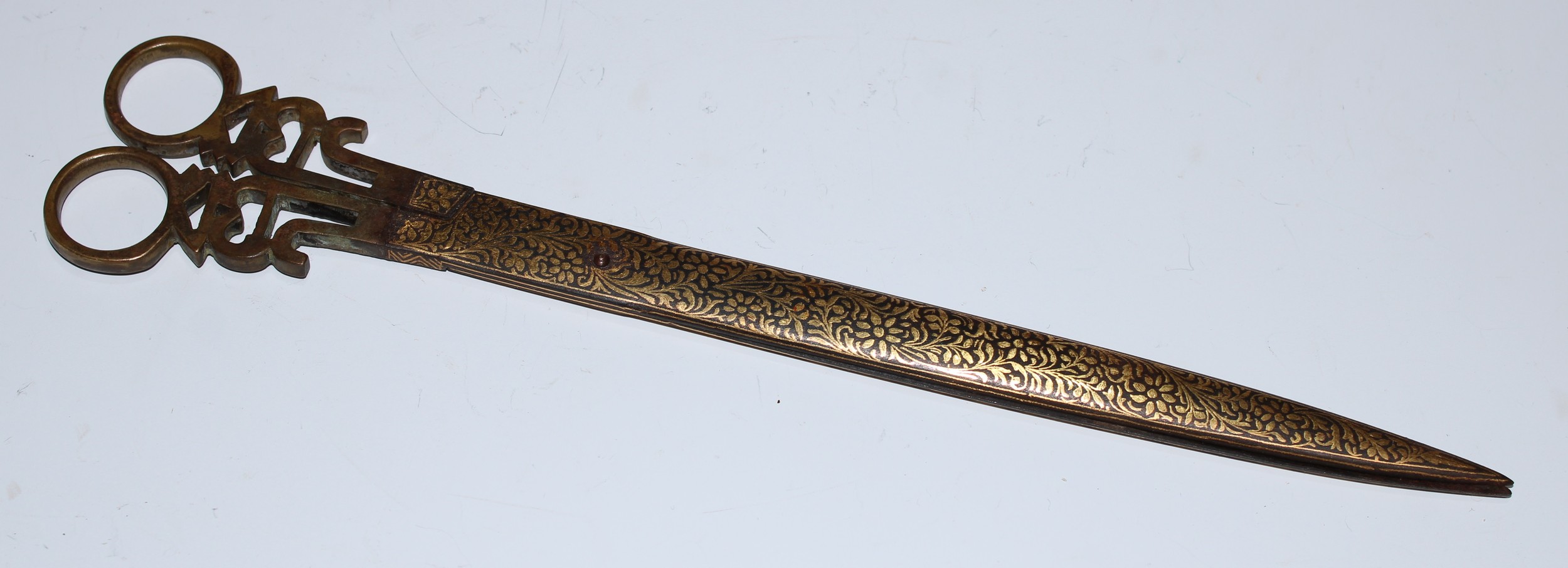 A pair of Middle Eastern Islamic calligraphy scissors, profusely damascened in the Persian manner with gilt scrolling foliage, 25.5cm long, 19th century