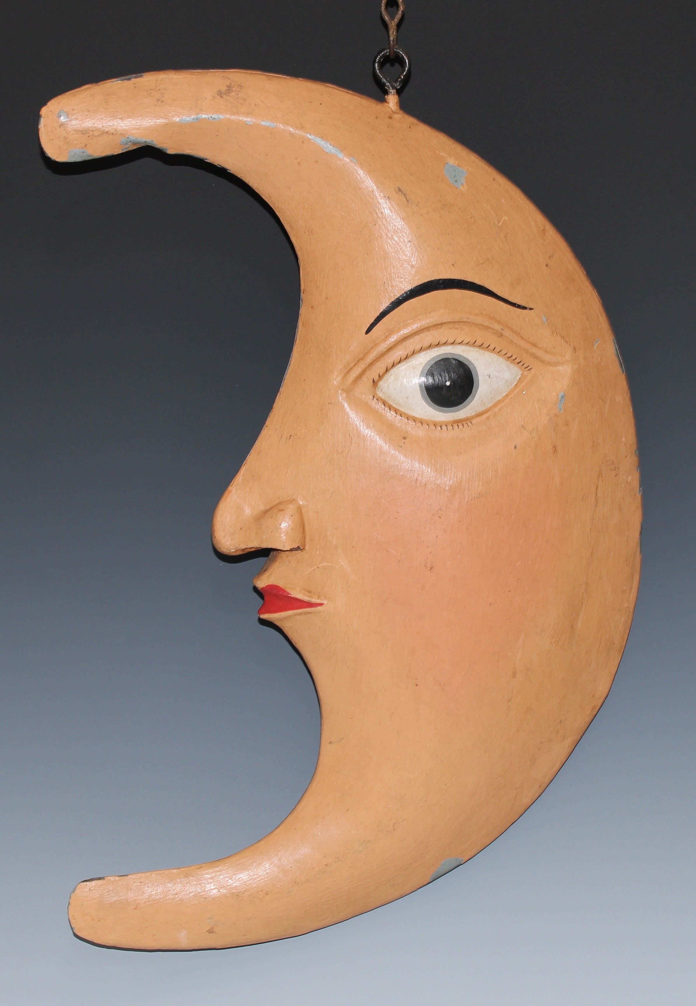 An early 20th century painted zinc sign or decoration, possibly for a shop or pub, as an anthropomorphic crescent moon, 39.5cm long