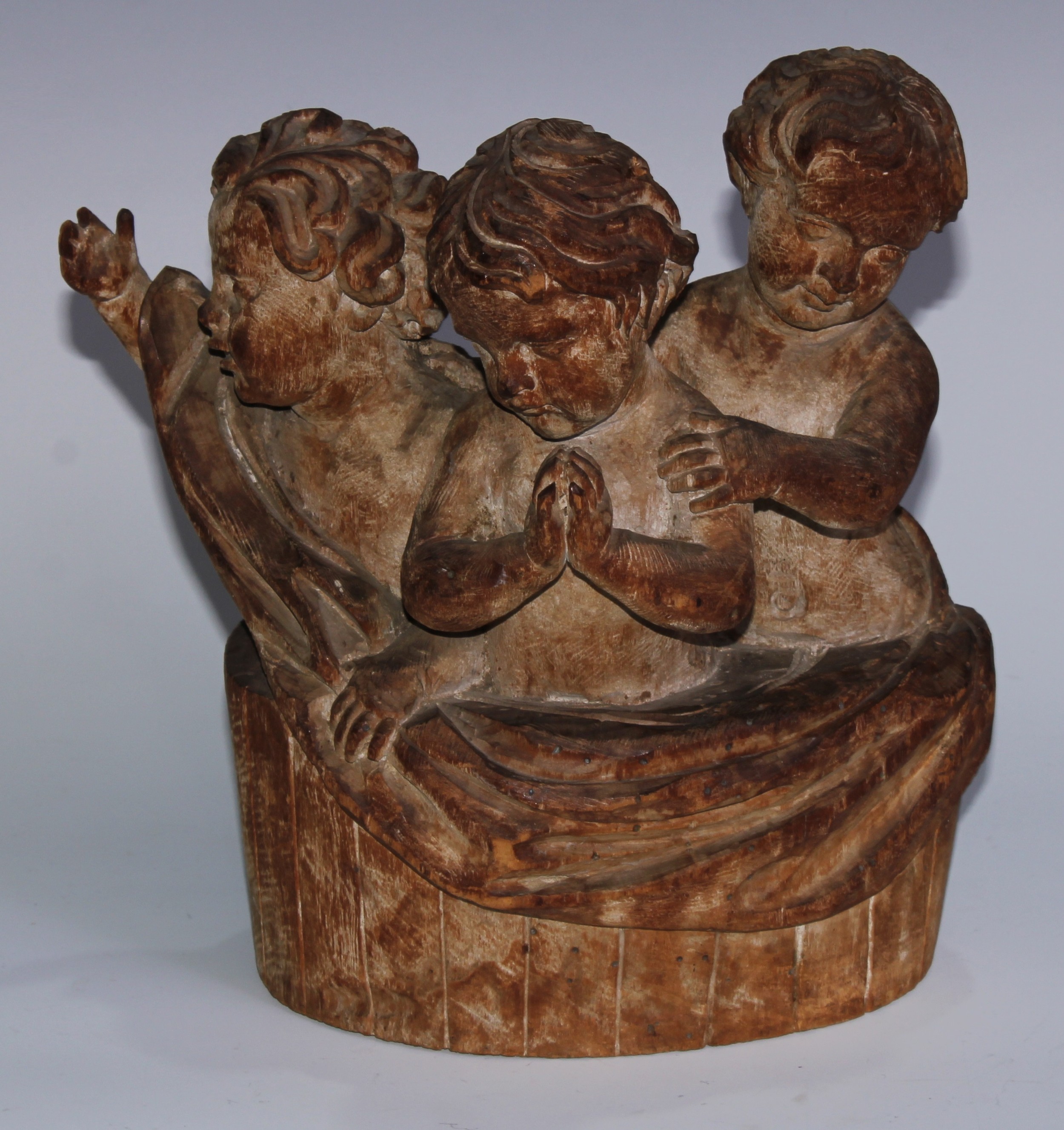 A sculptural Continental softwood carving, as a choir of putti within a swag-draped gallery,  23cm wiode, 18th/19th century