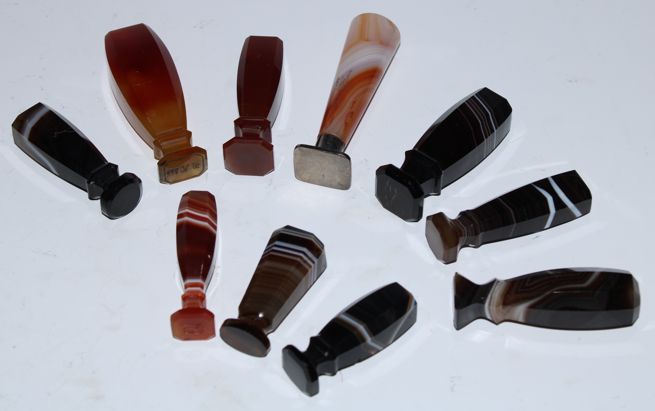 A collection of 19th century agate desk seals, various stones and matrices, the largest 7cm long