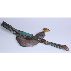 A Middle Eastern silver coloured metal mounted jambiya, 15cm curved blade, filigree scabbard, 28cm long overall