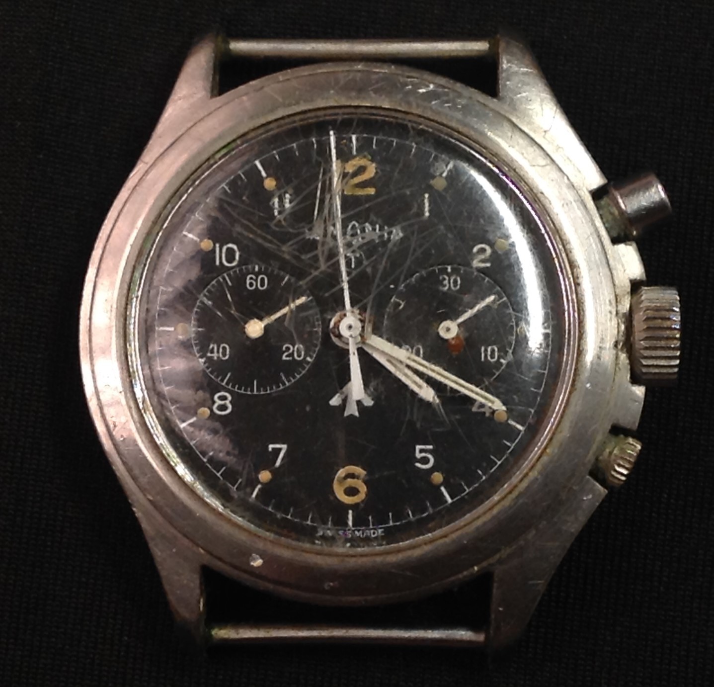 Post War 1970's British Military issue twin button Lemania Chronometer watch head, black dial, twin subsidiary registers, Arabic numeral and dot baton markers, centre seconds, stainless steel case, marked 0552/624-3306 4390/75, beneath broad arrow issue stamp, 40mm wide. (faults)