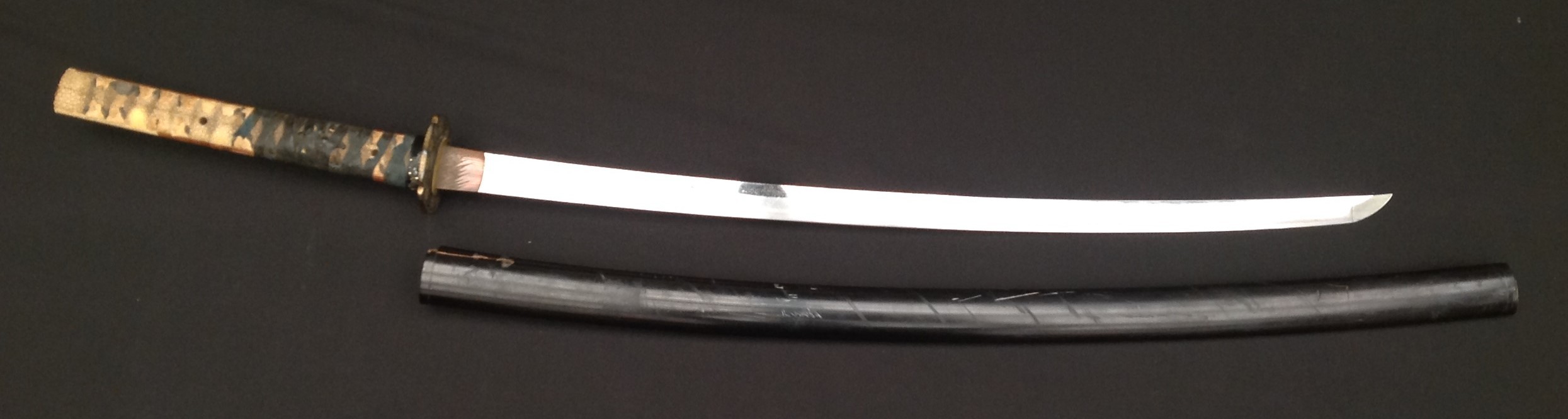 Japanese Katana Sword with 650mm long single edged blade. Tang is signed (Chrysanthemum-mon) Tanba no Kami Yoshimichi. Overall length 900mm. Complete with black lacquered Saya scabbard.