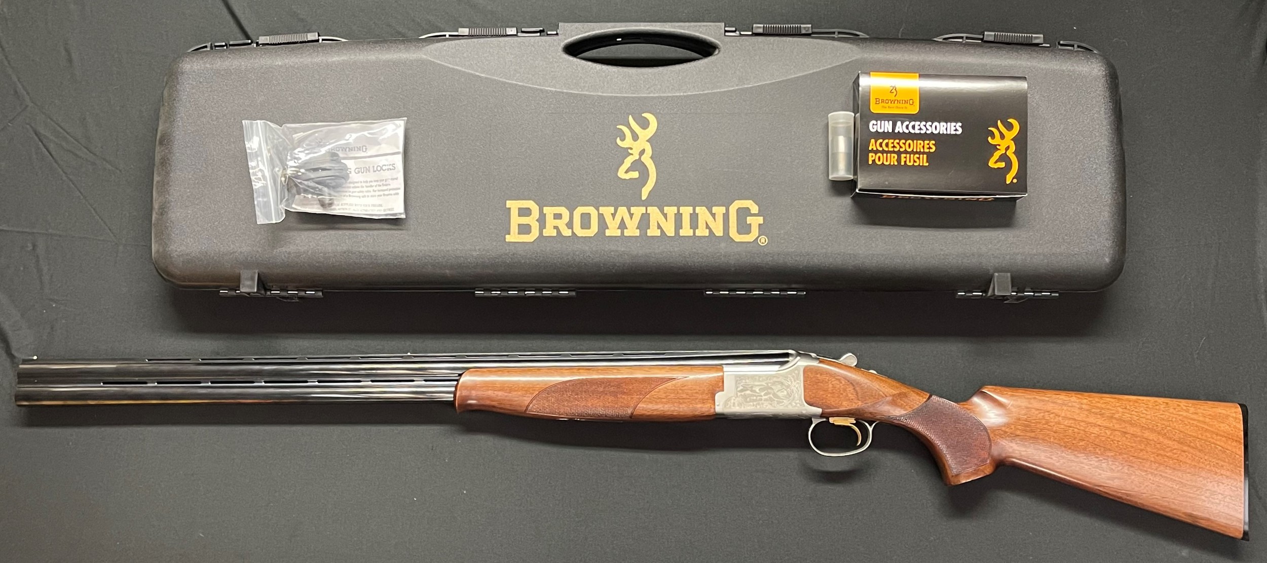 Browning Model 525 12 Bore Over and Under Shotgun with 762mm long barell, serial no 63167MP. Overall length 120cm. Engraved decoration to receiver featuring Game birds. Comes in original case with spare Chokes and with original sale invoice and warranty from 2009. NOTE: Buyer must hold a valid Shotgun Certificate or be a Registered Firearms dealer.
