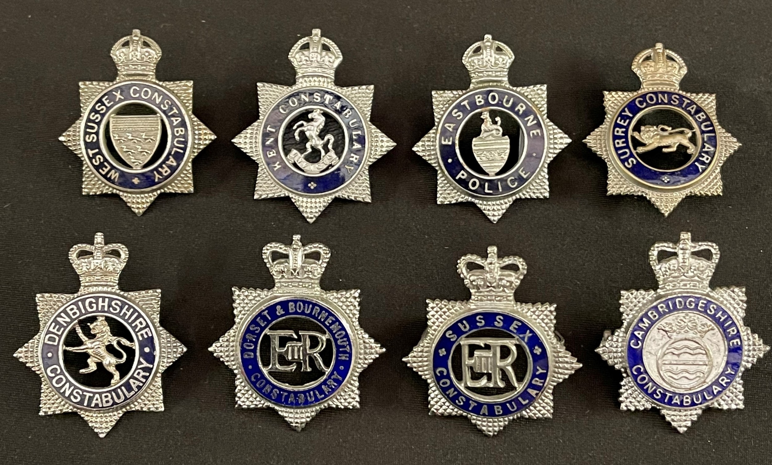 Police Officers Enamelled Cap badge collection to include: Kings Crown Kent Constabulary: Kings Crown West Sussex: Kings Crown Surrey Constabulary: Kings Crown Eastbourne Police: Queens Crown Dorest & Bournmouth Constabulary: Queens Crown Denbighshire Constabulary: Queens Crown Sussex Constabulary: Queens Crown Cambridgehire Constabulary (8)