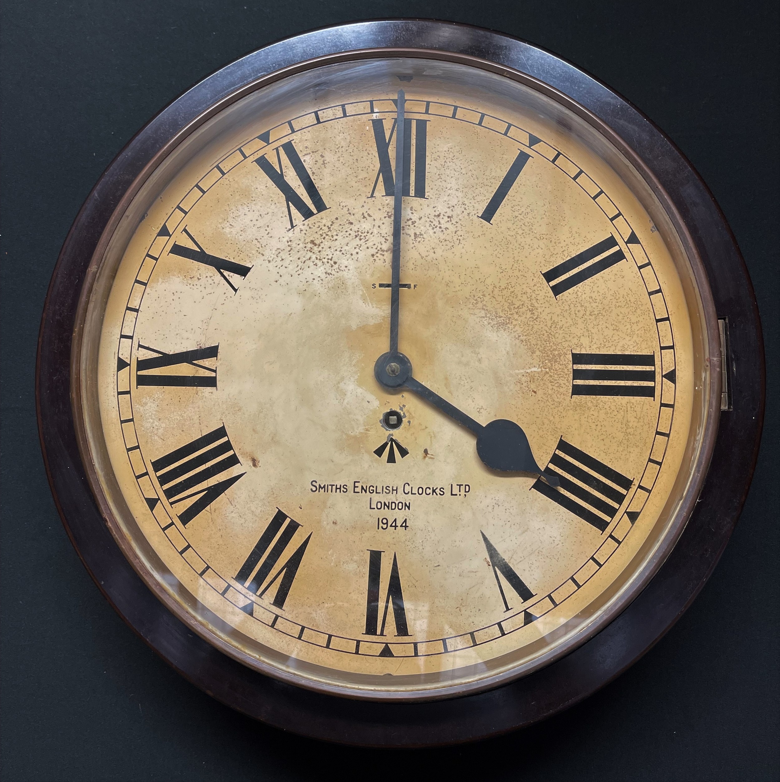 WW2 British WD marked Smith's Bakelite wall clock, dated 1944. 33cm dial. 42cm overall width. Wooden case around movement which is fixed. No key.