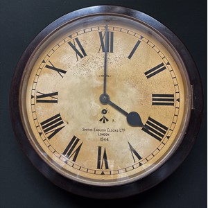 WW2 British WD marked Smith's Bakelite wall clock, dated 1944. 33cm dial. 42cm overall width. Wooden case around movement which is fixed. No key.