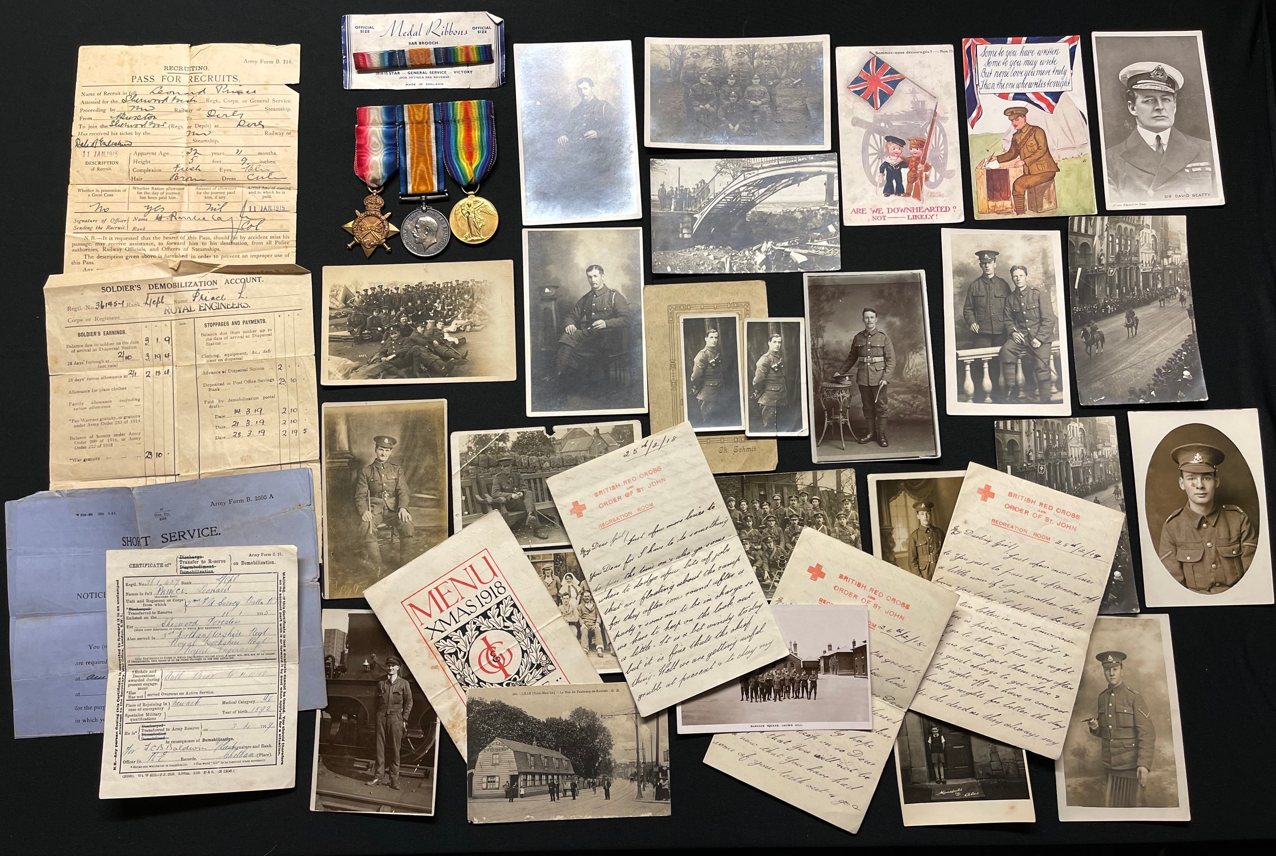 WW1 British 1914-15 Star, War Medal and Victory Medal to 19479 Pte Len Prince, Northamptonshire Regiment, mounted on a bar complete with original ribbons: medal ribbons for same on original sales card: motor fuel ration book, 1918 Xmas menu from Lille France signed by comrades; 21 photo postcards: very extensive family documentation archive. He also served with the Notts & Derbys and the Royal Engineers.