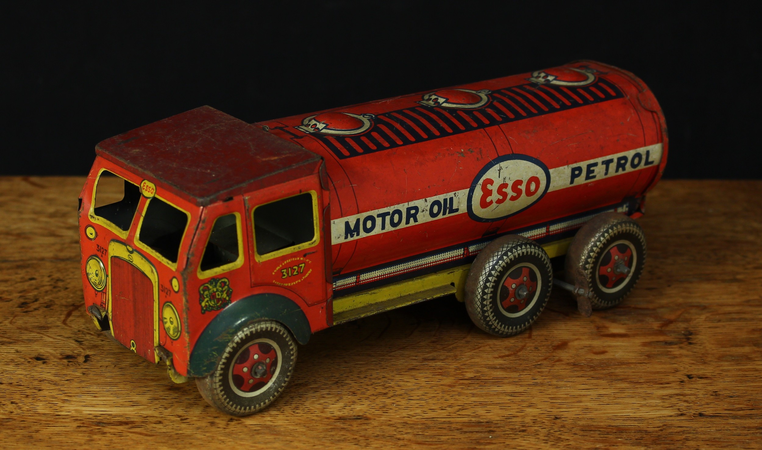 A Mettoy tinplate and fixed key wind petrol tanker, red body with lithographed detail, yellow chassis, “ESSO, MOTOR OIL, PETROL” to sides, No.3127A, 25cm long, unboxed