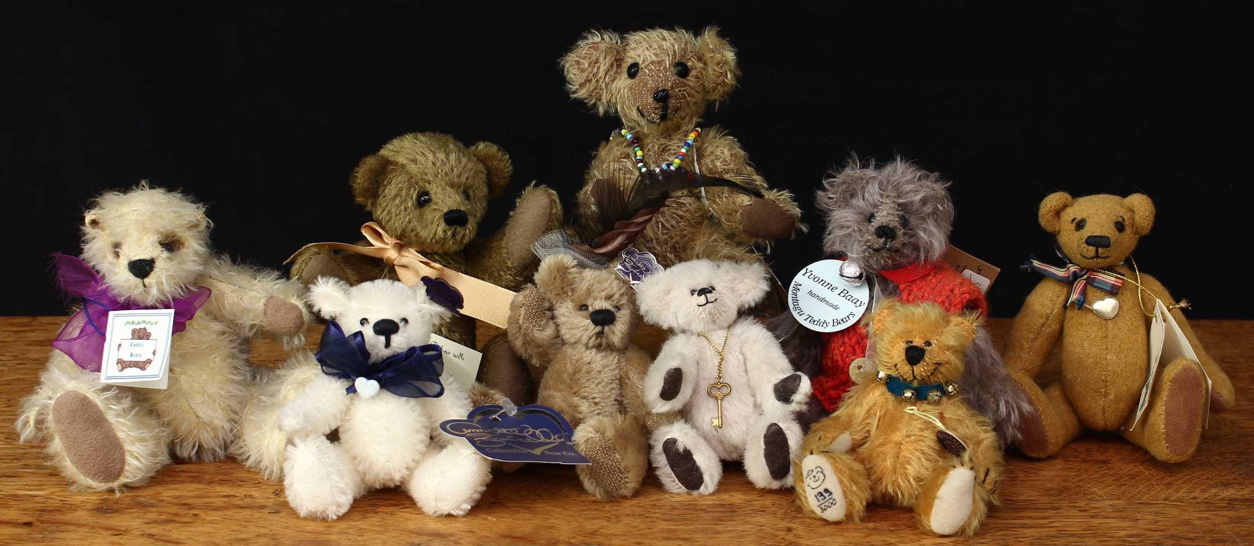 A collection of miniature artist teddy bears, comprising a Mayfair Edition miniature teddy bear, 11cm high with tag, Limited Edition No.199 of 3,000; a Cuddle Bears (South Africa) Baunabus miniature teddy bear, 16cm high with tag; a Cuddle Bears (South Africa) miniature teddy bear, 15cm high with tag; a Yvonne Baay Montagu teddy bear, 17cm high with tags; a Bear of Trust 2001 miniature teddy bear, designed by Lindy-Poos, 18cm high with tag, Limited Edition No.3; other miniature teddy bears including Africa Silks, Bears of Afrika by Bev Duncan etc (10)