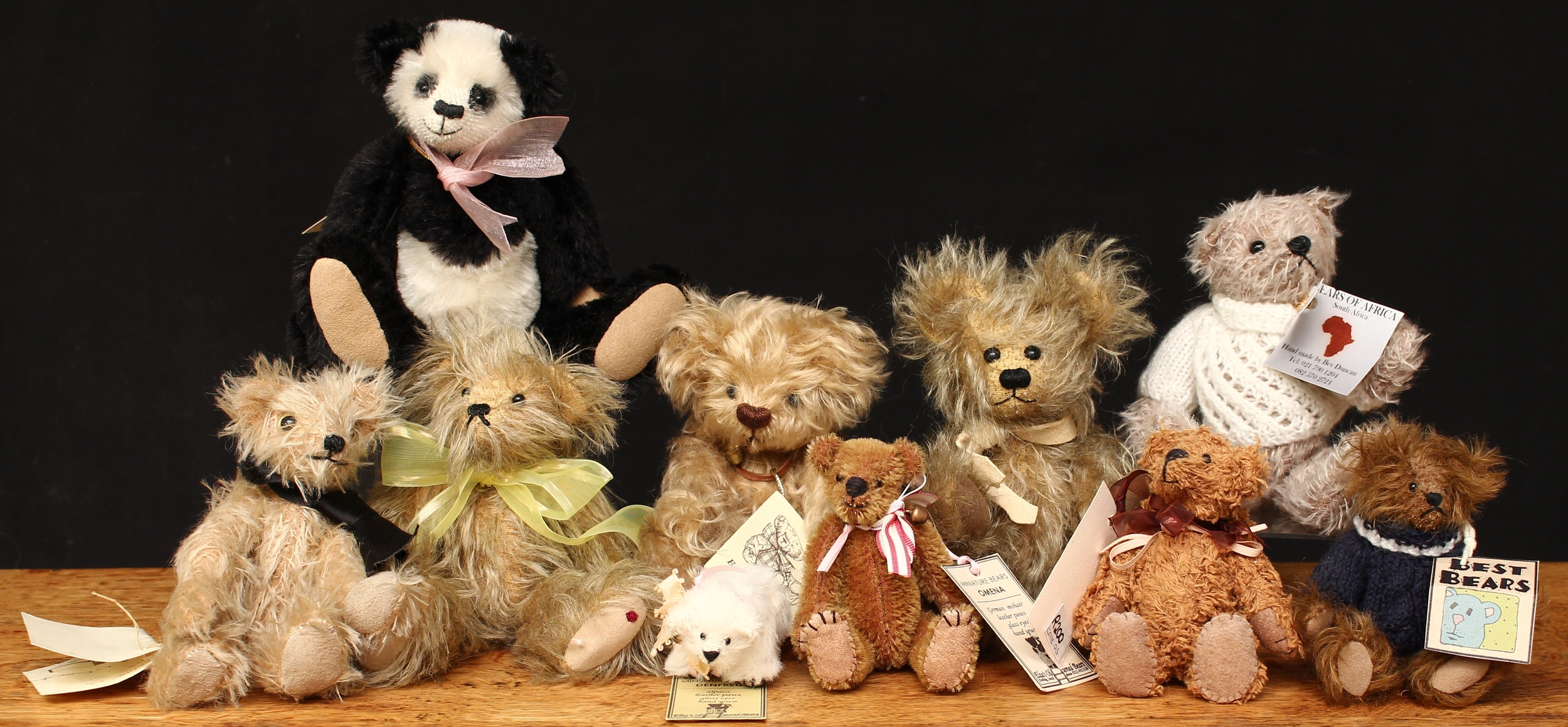 A collection of miniature artist teddy bears, comprising a Cuddle Bears (South Africa) miniature Panda teddy bear, 20cm high with tag; Elza’s Old Fashioned Bears (South Africa) Egberta miniature teddy bear, 12cm high with tag; Elza’s Old Fashioned Bears (South Africa) Omena miniature teddy bear, 12cm high with tag; Bears ‘n’ Things (Tasmania, Australia) Homer miniature teddy bear, designed by Jean Kelleher, 18cm high with tag; Bears by Frankie Woody miniature teddy bear, 18cm high with tag; Elza’s Old Fashioned Bears (South Africa) Denfred miniature teddy bear, 9cm high with tag; other miniature teddy bears including Barker Bears (10)