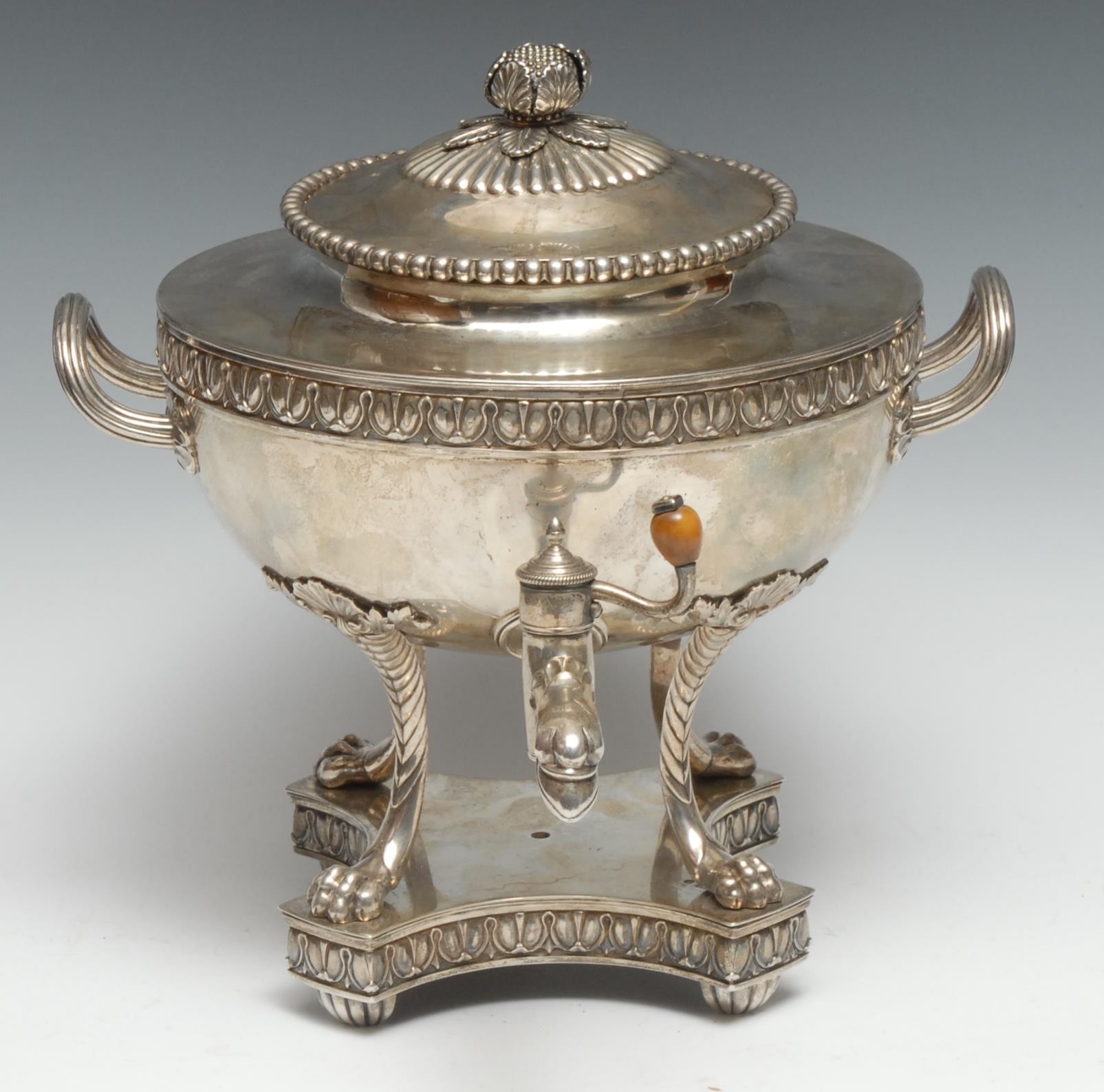 Irish Interest - a George III Neoclassical silver samovar, domed half-fluted cover with bud finial above a frieze of lotus, eagle tap, reeded scroll handles, lion paw feet, incurved canted square base, 25cm wide, Benjamin Smith II & James Smith III, London 1809, 66oz gross 
