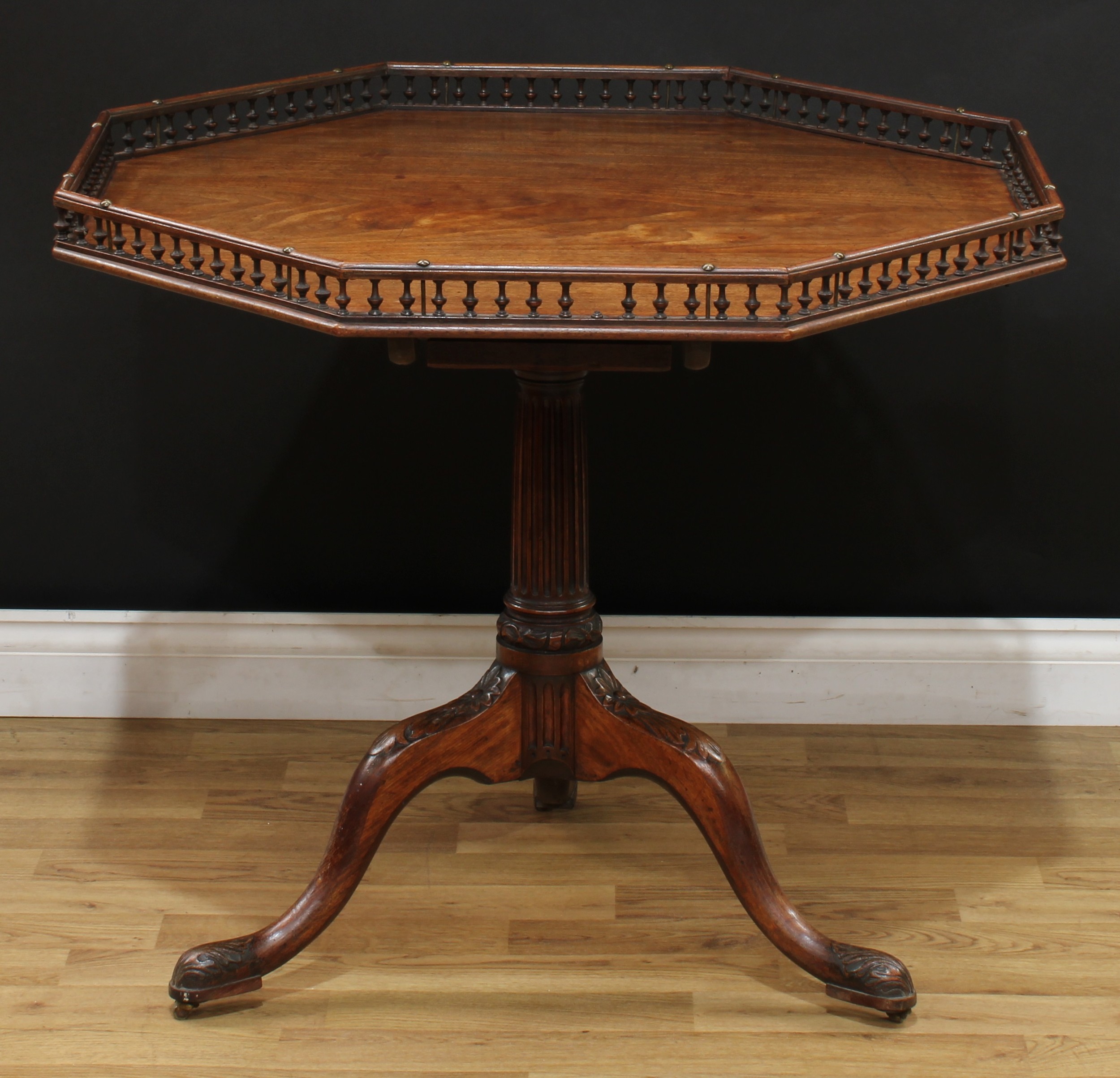 A 19th century mahogany octagonal tripod silver table, tilting top with baluster gallery, birdcage support, fluted pillar, cabriole legs carved with acanthus, pad feet, 74cm high, 85cm wide
