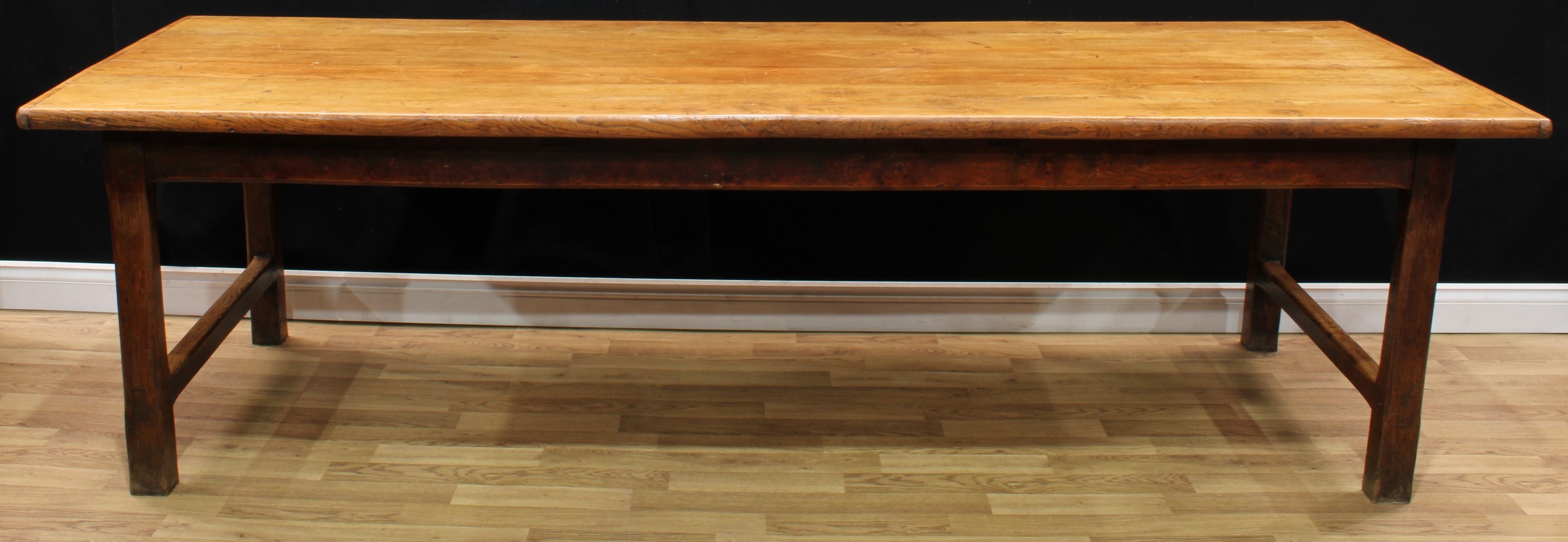 A large 19th century chestnut refectory table, oversailing top above a deep frieze, the underframe of pegged construction, 76cm high, 270cm long, 95cm wide, reputedly made for The Manoir Da Haye-Belfonds, Arromanches, Normandy, c.1830