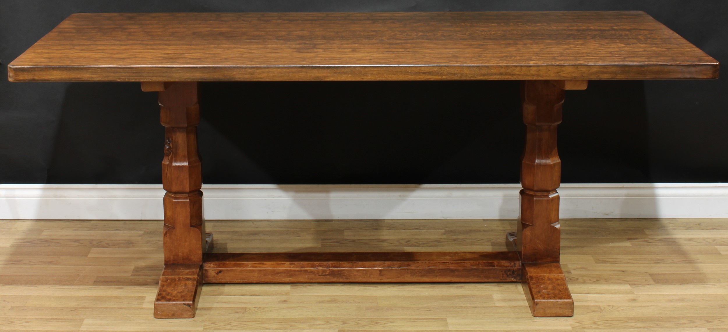 Robert Thompson, Mouseman of Kilburn - an oak refectory trestle dining table, adzed rectangular top, octagonal pillars, one with carved mouse signature, rectangular stretcher, sledge base, 74cm high, 183cm long, 87.5cm wide