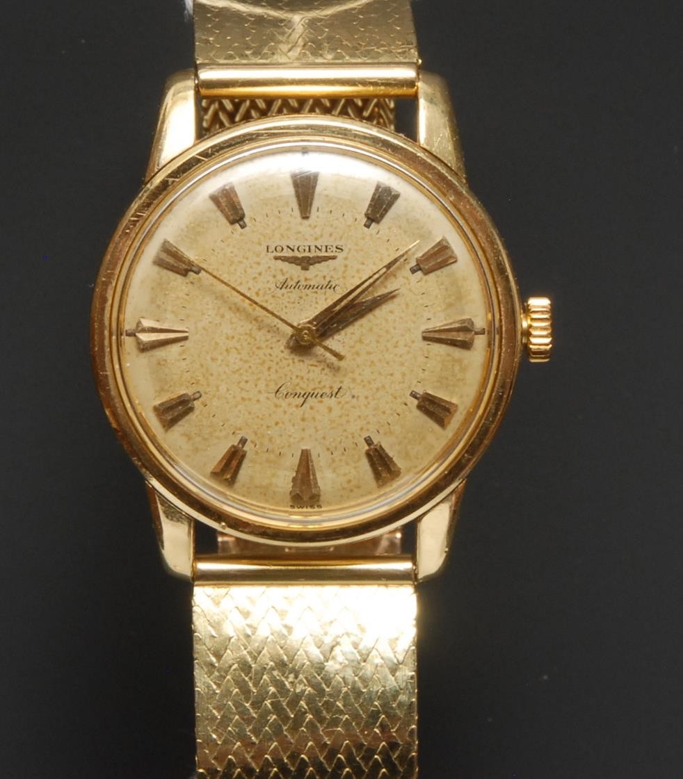 Longines - a Conquest automatic gold cased wristwatch, textured dial, centre seconds, shaped block baton markers, automatic movement, indistinctly marked case, Cartier Paris 18ct gold mesh link bracelet strap, deployment buckle, 101.8g gross