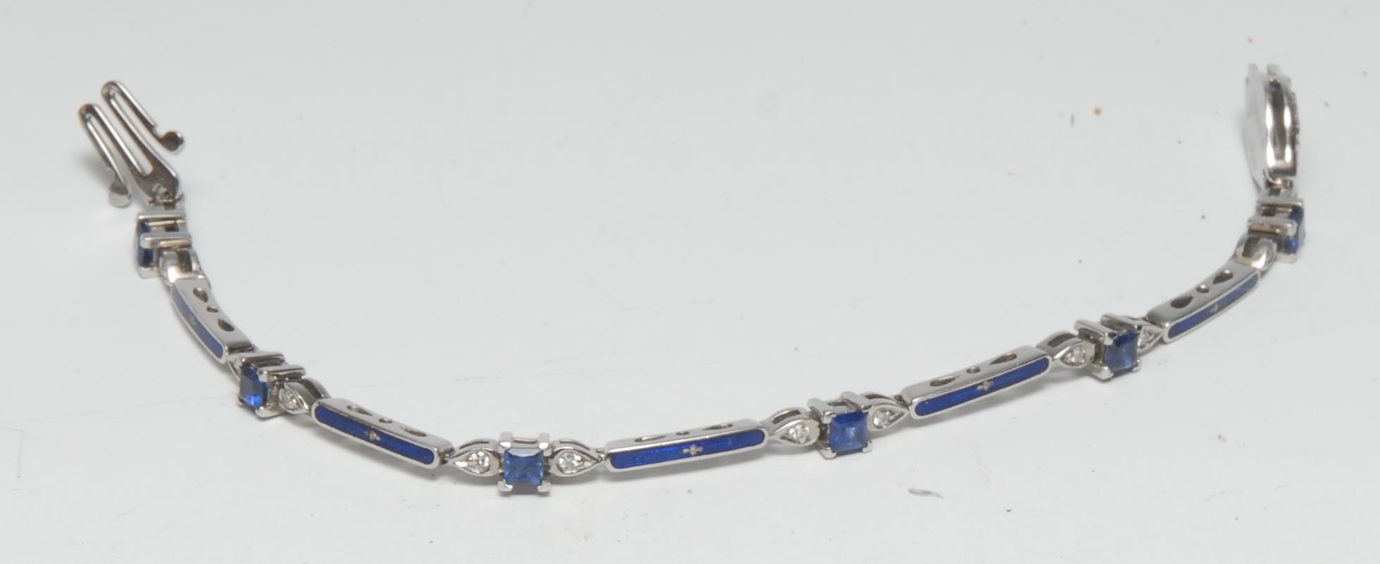 A Faberge limited edition 18ct white gold sapphire, diamond and blue enamel bracelet, inset with twelve diamonds and six blue sapphires, total stone weights diamond 0.28ct, sapphires 1.34ct, signed, 14/500, stamped 750, 16.5cm long, 17.8g gross, with certificate.