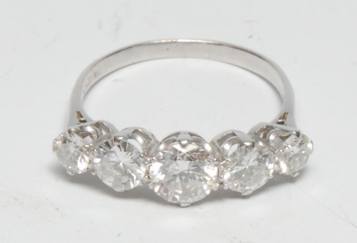 A five stone diamond line ring, linear set with five graduated round brilliant cut diamonds from approx 0.75ct to 0.25ct, total estimated diamond weight approx 2.25ct, platinum shank, size R, 3.3g gross