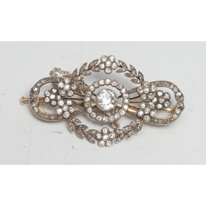 A gold and platinum diamond brooch, the central stone approx 0.50ct surrounded by a garland of diamond accented five petal flowers, unmarked yellow and white metal mount with safety chain, 44mm wide, 7.19g gross, boxed