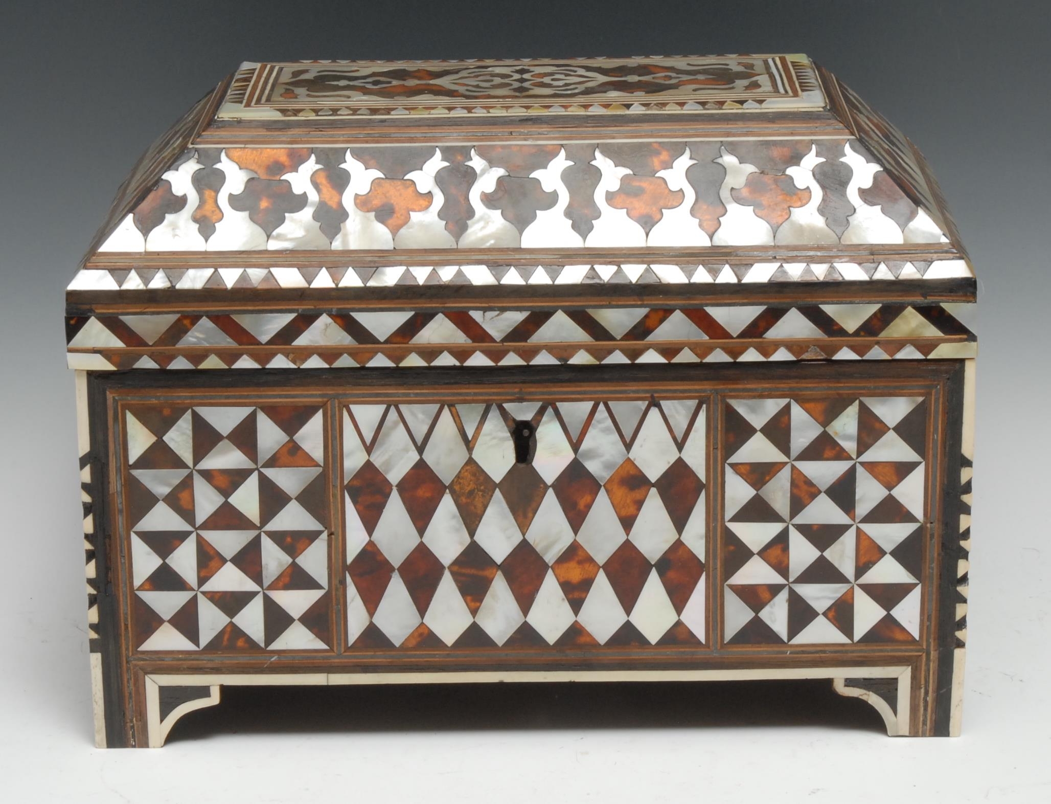 A 19th Century Ottoman Tortoise shell and mother of pearl veneered scribes casket finely decorated overall with trefoil chequered and kite shaped panels, wrought iron hinges, the paper lined interior with pen box, 32.5cm wide, 23 cm high, c.1800