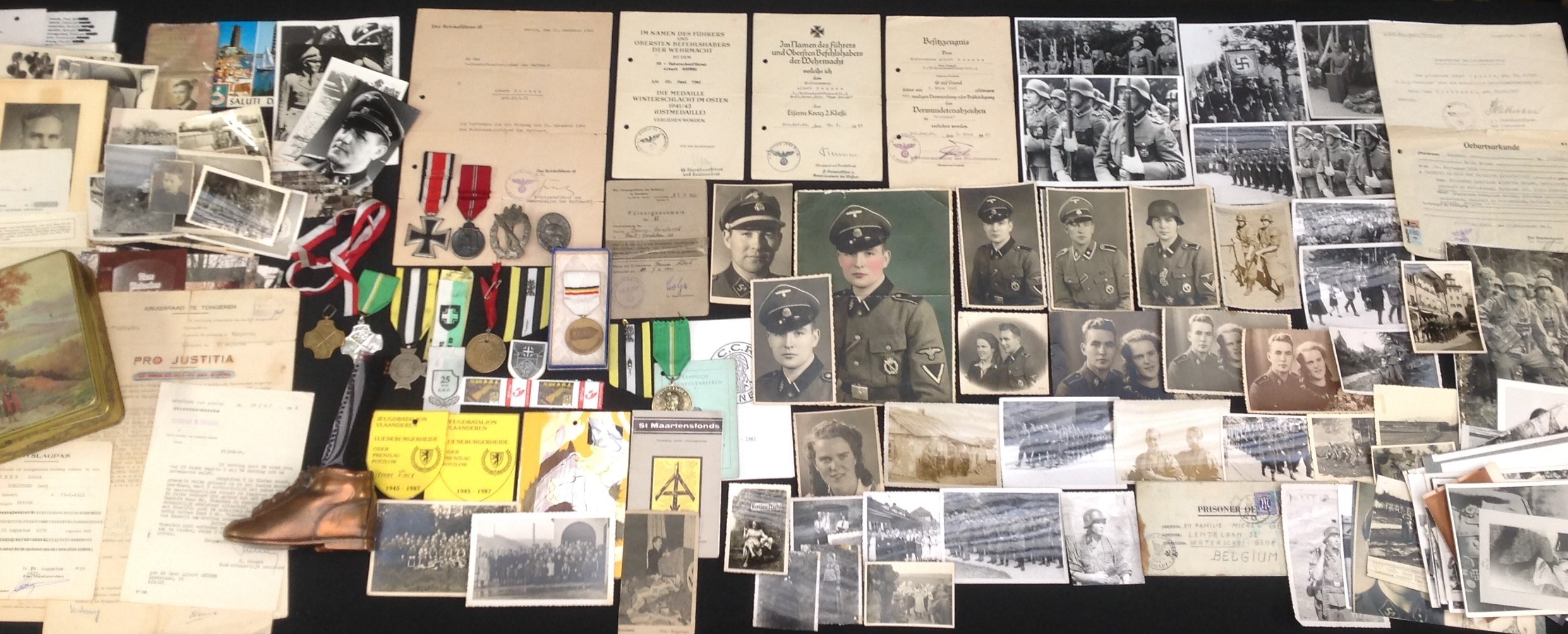 WW2 Third Reich Waffen SS Flemish Volunteers Group to SS Untersturmfuhrer Albert Geunes: a very comprehensive group of his awards, official documents and photographs. This is new to the market and has not been in a collection before to include: Eiserne Kreuz 2. Klasse, Iron Cross 2nd class 1939, no makers mark to ring, complete with original full-length ribbon: Award document for the EK2 to SS Sturmann Albert Geunes 3. /Kradschutzen-Btl.2 SS-PzGren. Div."Das Reich", dated 18.2.1943 and signed in ink by the divisional commander SS Gruppenfuhrer und Generalieutnant der Waffen SS Georg Keppler: Award document to SS Sturmann Albert Geunes 3. /SS Kradschutzen-Bt.2 dated 3 Marz 1943 for the Verwundetenabzeichen in Schwarz signed in ink by SS Sturmbannfuhrer und Btl. Kommandeur Jakob Fick (Fick was awarded the RK on the same day for the same action): Silver Wound badge 1939, zinc, maker marked L22, pin and hinge with old repair: Award document Medaille "Winterschlacht im Osten 1941/42" (Ostmedaille) to SS-Unterscharfuhrer Albert Geunes dated 22 Juni 1942 signed by SS Sturmbannfuhrer und Kommandeur Konrad Schellong, 6.SS-Freiwilligen Sturmbrigade “Langemarck”: Medaille "Winterschlacht im Osten 1941/42" (Ostmedaille) ring maker marked "14" complete with full length ribbon: Infanterie Sturmabzeichen in Silber - Infantry Assault Badge in Silver, zink, no makers mark: Promotion document dated 21 Dec. 1944 on Himmler’s personal headed paper with impressed seal and ink stamp promoting him to SS-Untersturmfuhrer and signed in ink by SS Brigadefuhrer und Genralmajor der Waffen SS Dr. Adolf Katz: Fursorgeauweis der Waffen SS in Flandern Nr.82 with ink stamp and signed: Medal of the Recruiting Centers 1940 ( Medaille van de Recruteringscentra van het Belgisch Leger 1940) awarded in 1990 by the Belgian Govt to men who presented themselves for service in France in 1940, cased and complete with ribbon and pin: approx. 30 wartime photos of himself in uniform: As he was an active member of the Sint Maartensfonds Flemish Waffen SS Veterans Association there are also approx. 40 post war reprinted photos of both himself and his comrades: 8 large post war reprinted photos of himself taking part in the honour guard at SS-Junkerschule Bad Tölz in 1944 for the memorial service for SS Brigadefuhrer Fritz Witt, shows Witt’s widow and children, Fritz Klingenberg, LSSAH colour party, SS Obersturmbannfuhrer Richard Schulze-Kossens etc: Four post war signed postcards/photos of Remy Schrynen, Richard Schulze-Kossens, Jan Vincx, etc: 10 colour photos taken in 1988 of the Memorial to Flemish SS killed in 1945 Nordwestuckermark-Sternhagen, Uckermark district, Brandenburg : Wartime newspaper cutting of Jef van de Wiele: His Daughters Birth Certificate born in Germany 25th Sept 1944: photocopy of letter to his Adj. Obersturmfuhrer Buch sent from Graz 6/3/44: Letter sent as a PoW to his family 30/6/46: Copy from the Bundesarchive sent to him by Jan Vincx of him listed in the 14 Kreigs-Juncker- Lehrgang an der Junkerschule Tolz: 1941 Regt Westland document giving him permission to marry signed by unit Kommandeur  SS-Stubaf. Horst Strathmann: 5 wartime photos of his wife and Flemish HJ members: 3 documents from his Military Tribunal in 1946/47: release papers with photo after he was released from prison in 1958: After released he became a Miner, Belgian Trade Union /Algemeen Christelijk Vakverbond Bronze Medal" ACV Hulde: En Erkentelijkheid": Belgian Trade Union /Algemeen Christelijk Vakverbond Silver Medal" ACV Hulde En Erkentelijkheid": Medallion from a Miners Jubileumfeest Dinner and menu from 1982: Miners ID card with photo: St Maartensfonds Membership Card with stamps from 1975-1977: Sint Maartensfonds Commemorative Medal 1951-1996: ribbon pins stamps 1980’s/1990’s from re-reunions: lapel badge “JST” (Junkerschule Tolz): Medallion “Tychsen Kameradschaft, 2nd SS Panzerdivision Das Reich”: Official copy of trial Pro Justitia: Handmade 1997 New Year card from another Veteran with collar tab illustration to front: post war family photos of his daughter and her husband, inc his military service in the Belgian Army, etc, etc. Post war photos of the graves of SS General Paul Hausser and of Hitler's parents.