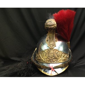 French Republican Guard of the City of Paris Cuirassier helmet. Maker marked to rear of helmet "Siraudin & Hersant". Also stamped with various issue accountability numbers to the rear of the helmet body. The body is silvered metal with the edges banded in gilded brass. The gilded comb is decorated on both sides with volutes and laurel leaves and the front bears the head of Medusa. A black horsehair tail hangs from the rear of the comb. Slightly convex chinscales on a soft black velvet backing are attached to two large bosses. A gilded socket on the left side supports a small red horse hair plume. Seven-fingered brown leather liner. Front and rear peaks are lined with brown leather. Name scratched into the leather on the rear peak "Houdep".
