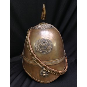 British Victorian 1st Yorkshires Other Ranks Helmet. Brass skull. Wreathed Queens Crown badge to front along with Lion's Mask to front peak. Spike to top on a leaf patterned base. Lion's mask mounts for chin chain. The chin chain is backed with brown leather. No liner or liner band. No leather to undersides of peaks. Uncleaned condition.
