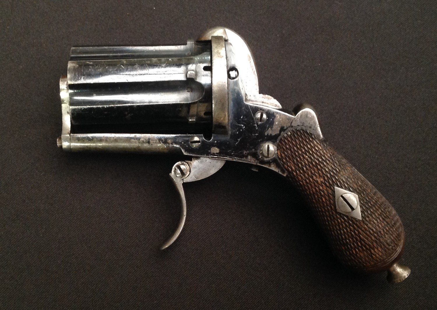 Pin Fire Pepperbox Pocket Pistol Revolver. 7mm Bore. Six shot. Cylinder length 45mm. Folding Trigger. English Proof marks. Cyclinder marked with "Crown B". No makers markings. Working double action. Much original finish still present. Overall length 115mm. Section 58, no licence required.