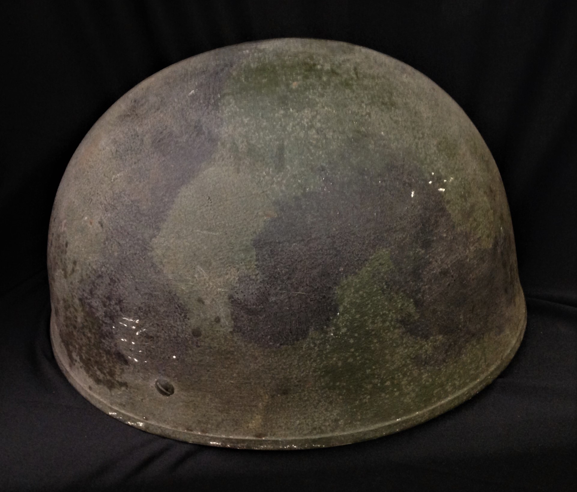 British Helmet Steel, Airborne Troops. MkIII Pattern helmet with original paint with black overpainted camo pattern. Complete with leather liner by BMB, size 6 7/8ths, dated 1949 and with web chinstrap with leather chincup. A press stud has been sewn to the end of the chinstrap to allow a quick release. Cushion Pad in the crown is loose. Original owners name written in ink to the sweatband "Pte Harrison 24171642".