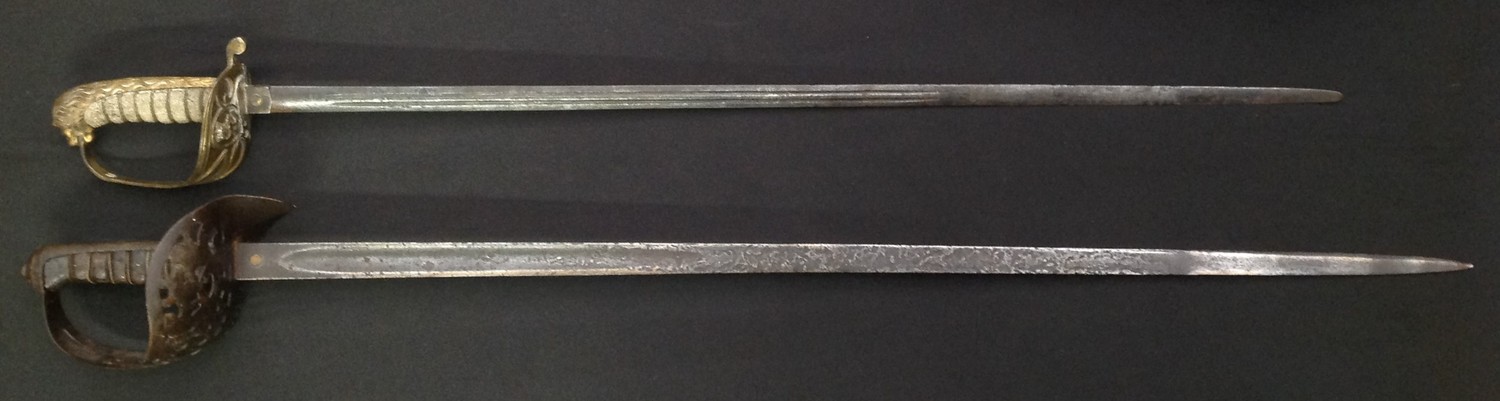 Pair of British Victorian Swords: Army Officers 1897 pattern with single edged fullered blade, 825mm in length, proof marked, overall length 975mm, no scabbard: Royal Navy Officers Sword with double edged double fullered blade 740mm in length. Folding guard, wire bound Shagreen grip, Lions Head Pommel. Overall length 880mm. No scabbard. (2)