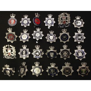 A collection of British Queens Crown Police cap badges all with coloured enamels to include: Metropolitan Police x 3, Northamptonshire Police x 3, West Mercia x 2, Gloucestershire  Constabulary x 2, Surrey Police, South Yorkshire x 2, Thames Valley, Suffolk Constabulary, West Mercia Special Constabulary, Warwickshire Constabulary, Hertfordshire Constabulary, Hampshire x 2, West Yorkshire, Cleveland, Wilts, etc. (24)