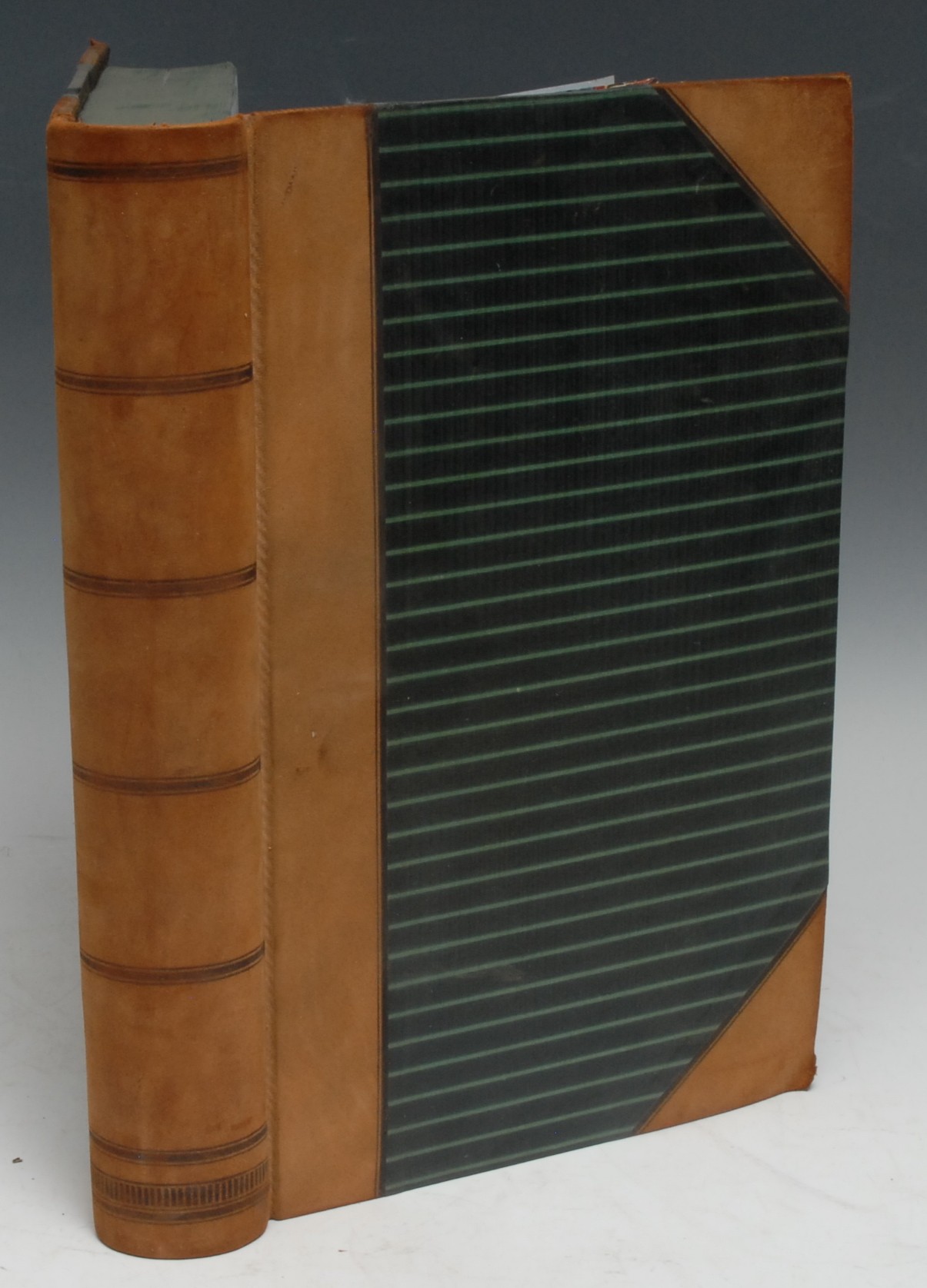 Bookbinding - a mid-Victorian local bookbinder's ledger, compiled by Joseph Burrows, Bookbinder, Nottingham, red-ruled blue paper, prefixed by an index of their clients, the 747 numbered pages of ink MS accounts partially-inscribed, with the date of the work (from 1858 and onwards), the title itself, and the cost of the binding or repair, unfortunately for the bibliographer there is a paucity of bibliographical information, 6 loosely-inserted sheets of manuscript accounts, contemporary half reverse calf over patterned boards, green-stained edges, marbled endpapers, 4to, [1]