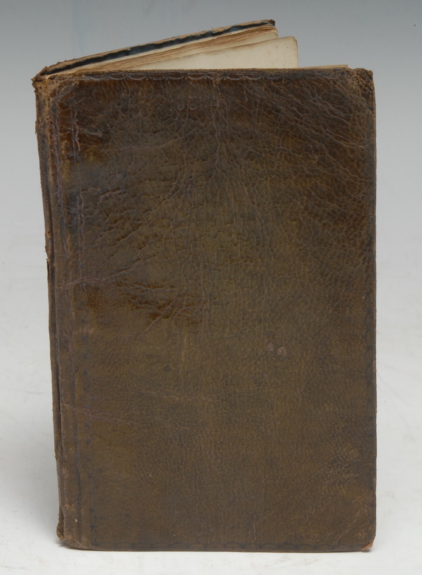 Victorian Humour in a Graphic Didactic Primer - an illustrated manuscript, comprising two works, each with a separate title-page, Passions of Ye Period, [&], A Few Clippings from Mavors,/ [with] Spelling Book, pp: [i] (watercolour frontispiece), [10], [1] (blank), [1] (allegorical watercolour colophon of a jester observing the passage of time with a pocket watch); [38] (interspersed with a few blanks, not collated), [1] (macabre colophon of a hanged cat), the relaxed instructive text is brilliantly illustrated with well-executed monochrome pen-and-ink drawings and cartoons, the artist-author must have had a sense of humour, as he relishes farce, the ridiculous, and pricking the stuffy pomposity of Victorian social mores, with parallels of the extremes of virtue and vice in 'Ye Passions,' set and illustrated in the Anglo-Saxon manner with 'illuminations' of lust, gratuitous violence, gluttony, and-so-on, the second part is well-illustrated by the same hand, but with more contemporary themes, fashions, and-so-forth, and also includes some novel and comic storyboards, unfortunately there are no inscriptions or dates as to identify this talented hand and its wicked humour, 19th century limp olive morocco , 16mo (16cm x 10cm), [1]