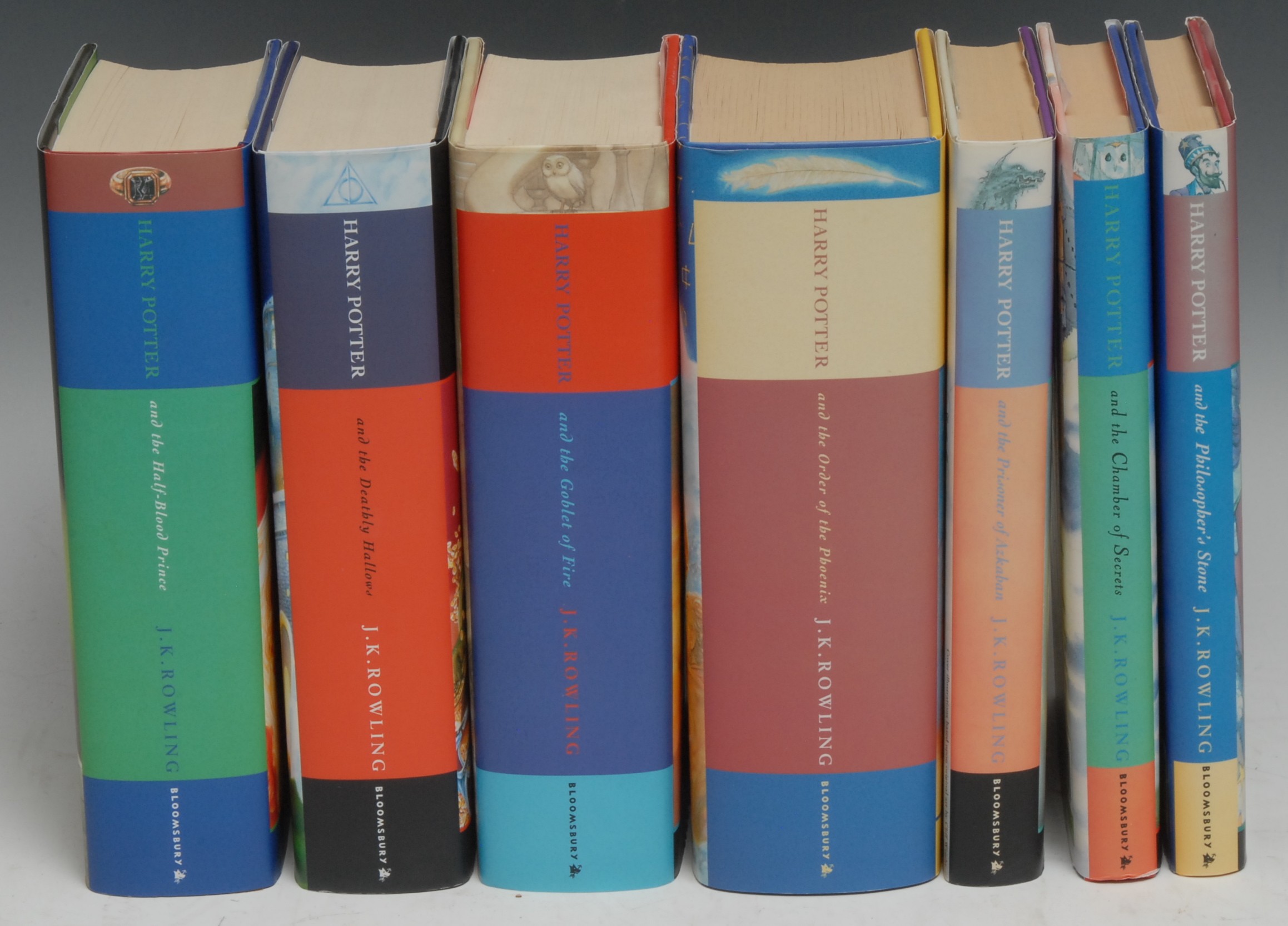 Rowling (J.K.), Harry Potter: The Philosopher's Stone, first edition, fifth printing, 1997, (1); The Chamber of Secrets, first edition, twentieth printing, 1998, (1); The Prisoner of Azkaban, first edition, second printing, 1999, (1); Goblet of Fire, first edition, eighth printing, 2000, (1); Order of the Phoenix, first edition, 2003, (1); The Half-Blood Prince, first edition, 2005, (1); The Deathly Hallows, first edition, 2007, (1), all Bloomsbury imprints, pictorial dustjackets over pictorial dustjackets, 8vo, [7]