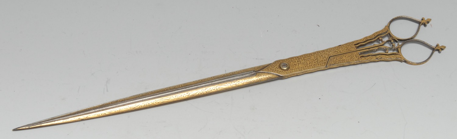 A pair of Middle Eastern Islamic calligraphy scissors, profusely damascened in the Persian manner with gilt scrolling foliage, 27cm long, 18th century