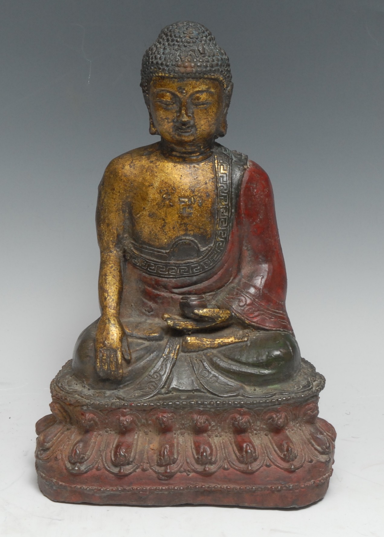 A Chinese cast iron Buddha, seated in meditation, lotus base, 26cm high