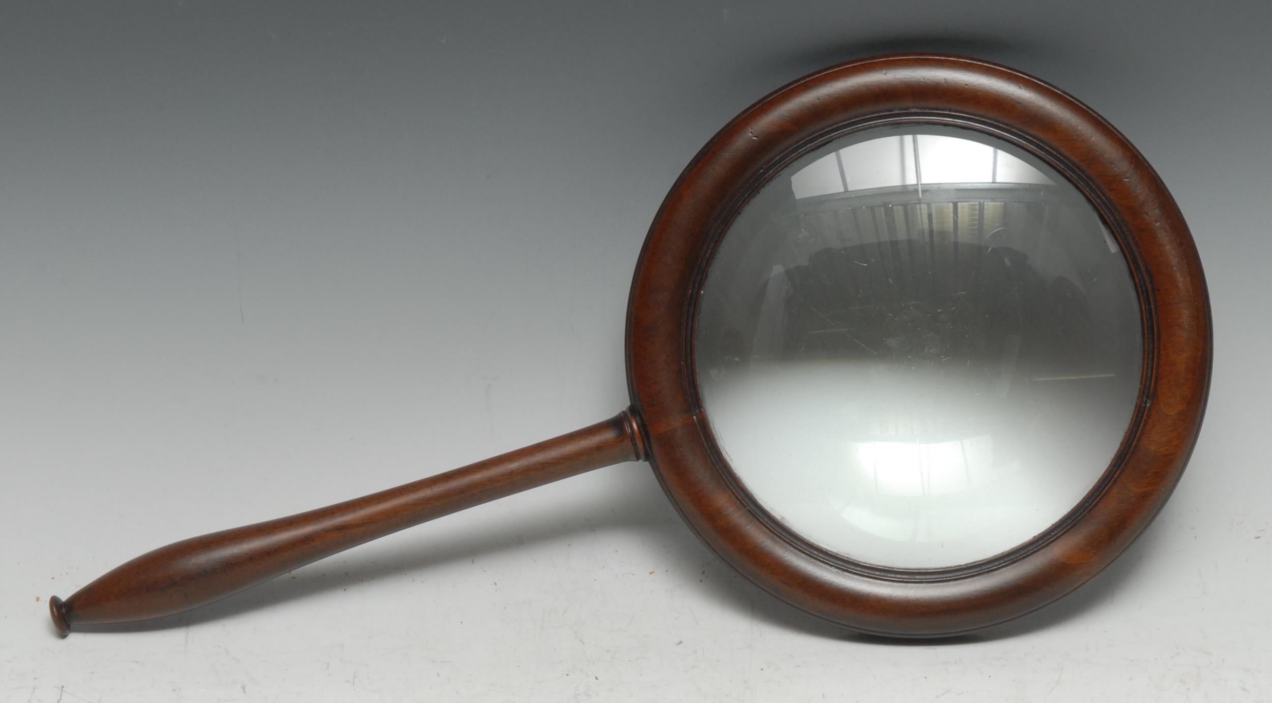 A large Regency mahogany connoisseur's lens, 15.5cm magnifying glass, reeded border, turned slender handle, 42.5cm long overall, c.1820
